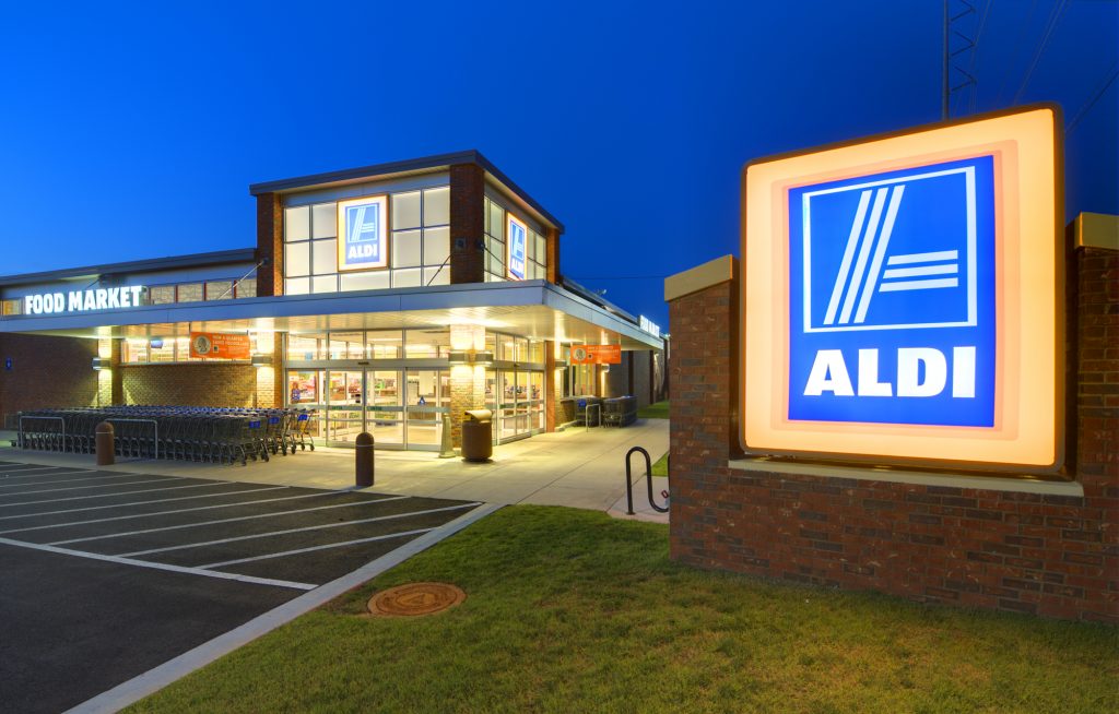 Necessity retail exterior at night—private placements operate outside broad advertising