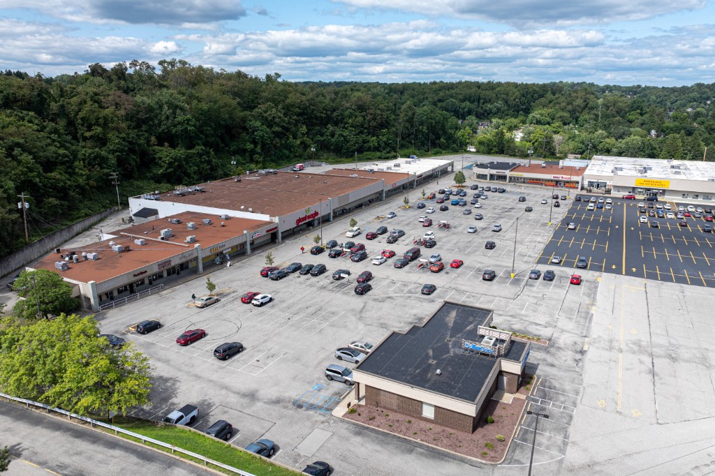 Aerial view of a retail plaza and parking